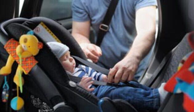 Newborn sleeping in car seat